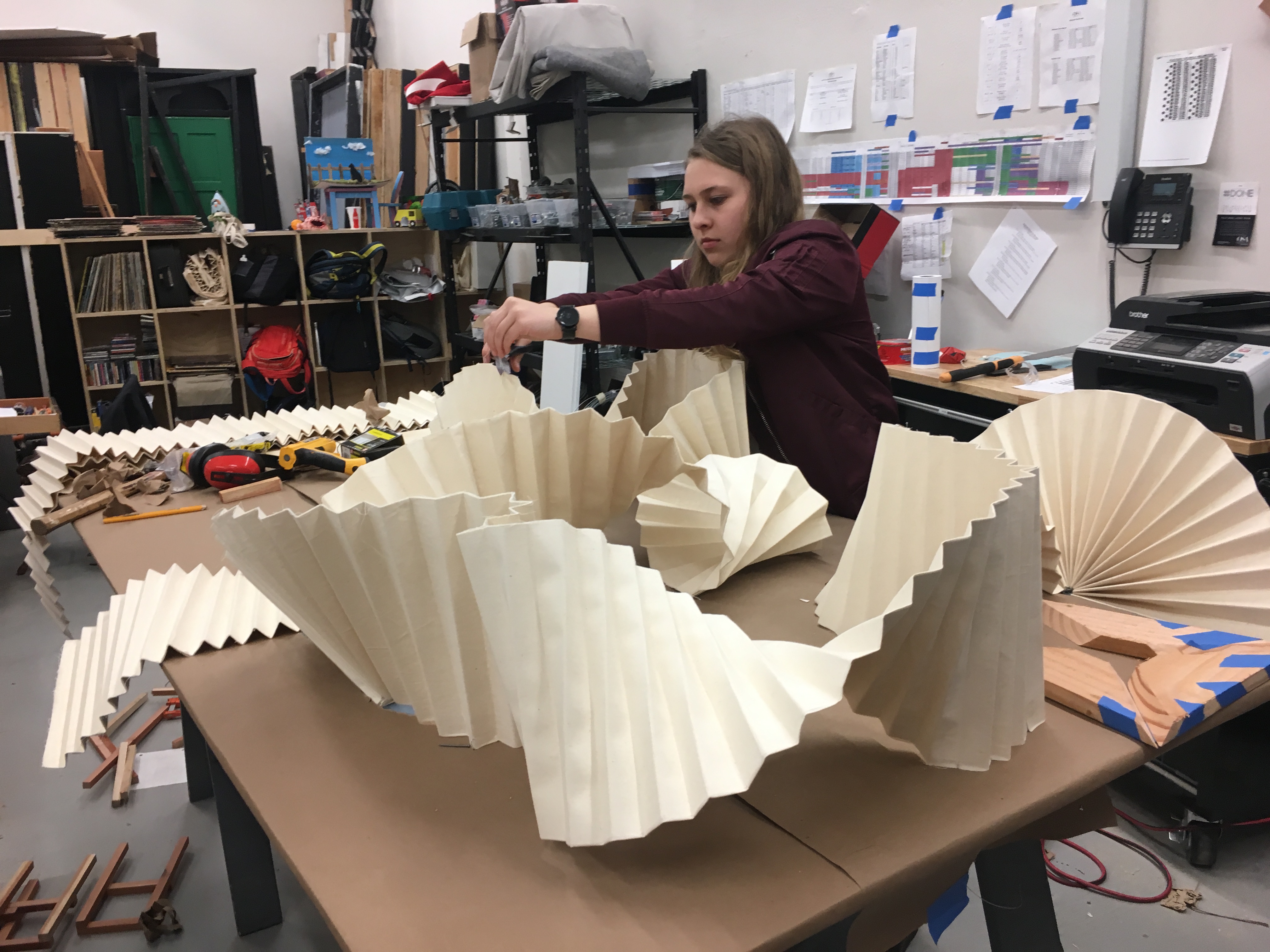 A female student working on a large art project